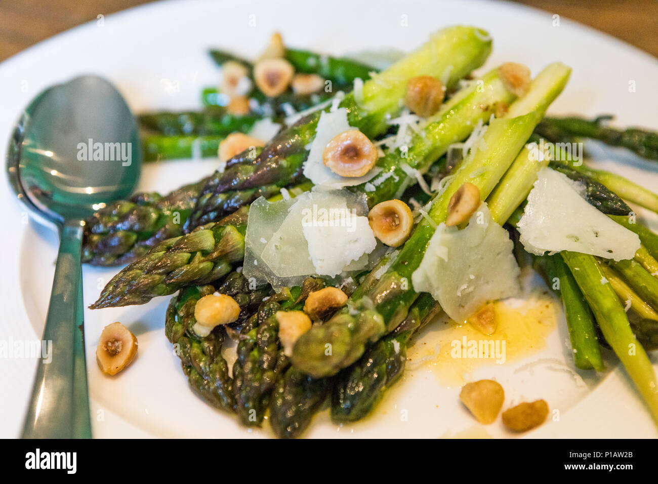 Asparagus with buttered hazelnuts and pecorino cheese. Stock Photo
