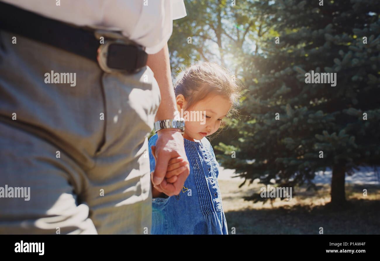 Grandfather holding hands with innocent granddaughter Stock Photo