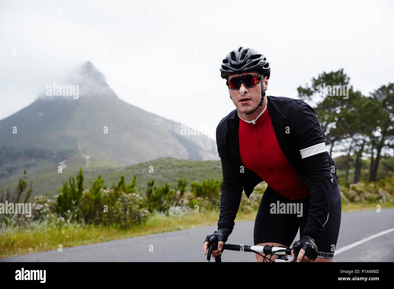 Portrait confident, determined male cyclist cycling on road Stock Photo
