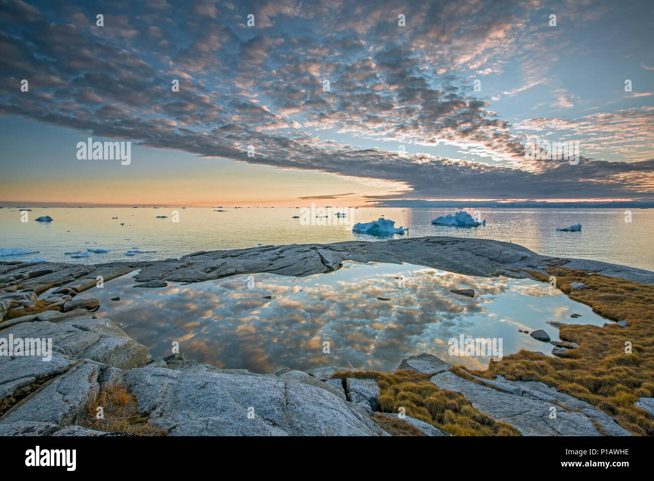 Idyllic clouds over remote ocean with icebergs, Kalaallisut, Greenland Stock Photo