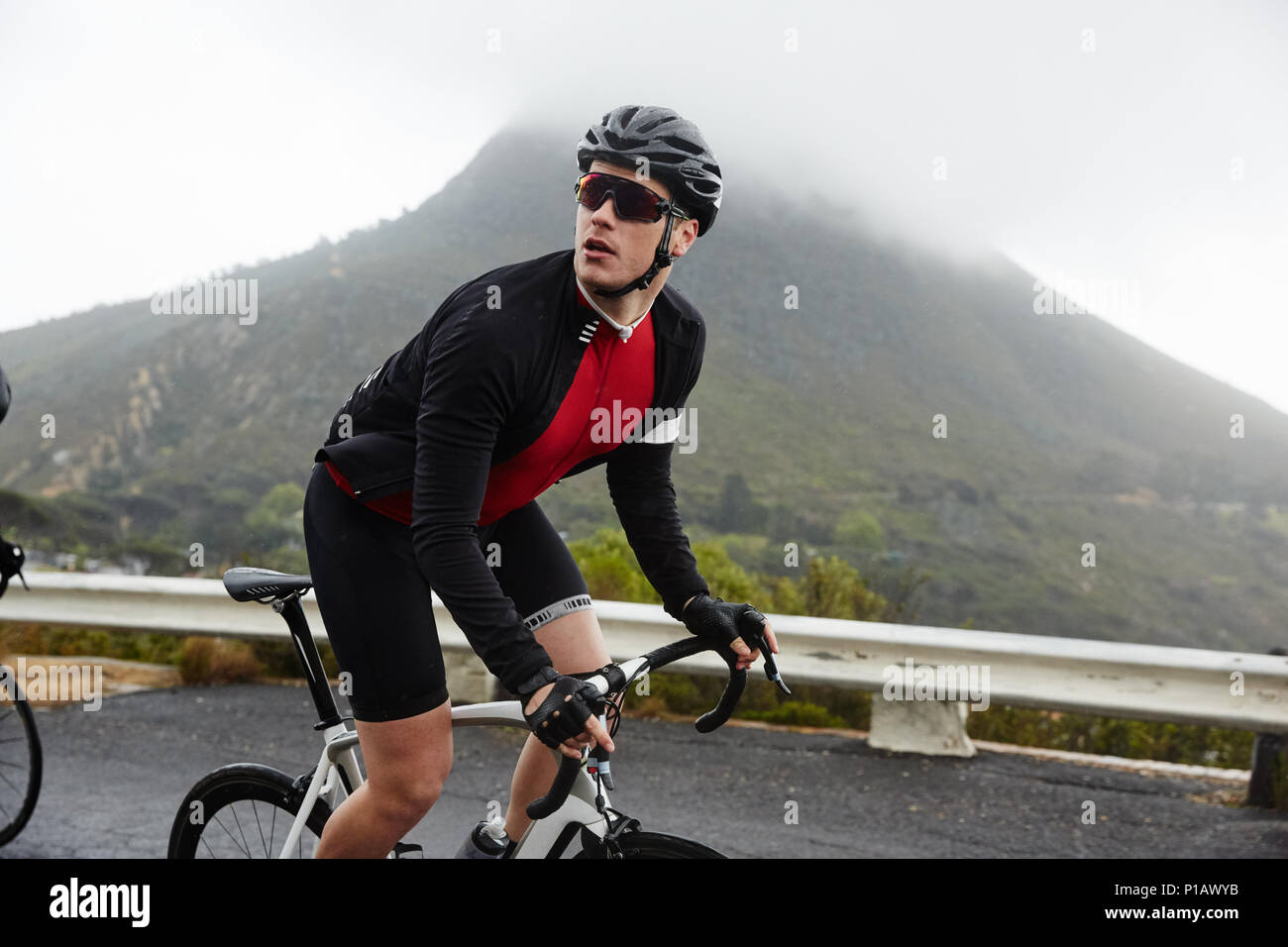 Male cyclist cycling mountain road Stock Photo