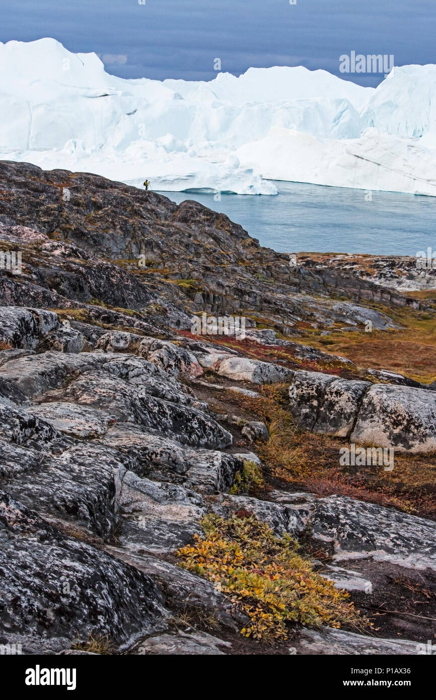 Iceberg With Rocks Icebergs beyond craggy rocks, Icefjord, Ilulissat, Greenland Stock ...