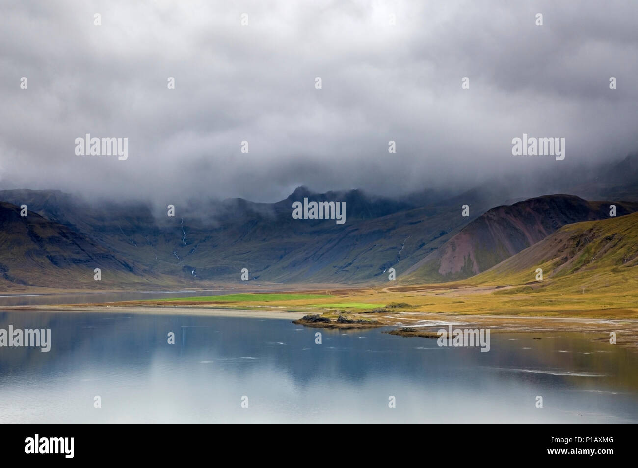 Clouds over remote landscape and water, Iceland Stock Photo
