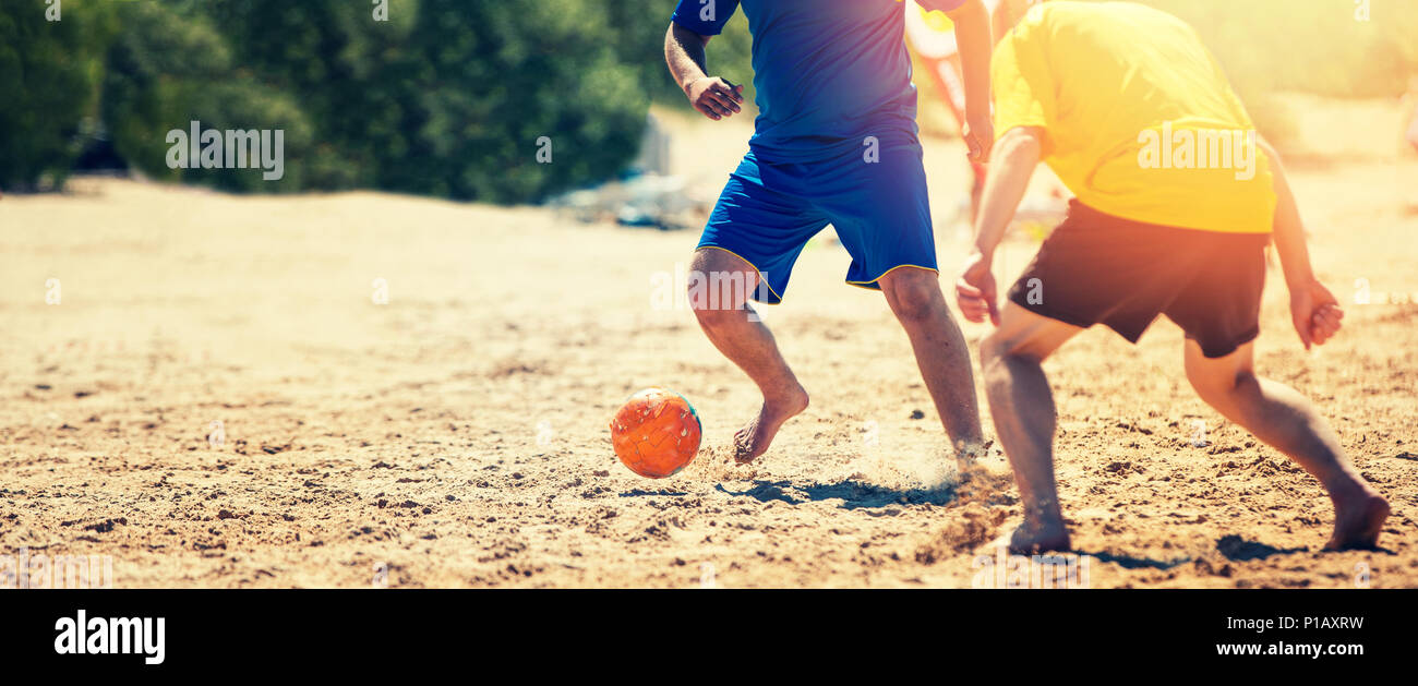 playing beach soccer Stock Photo