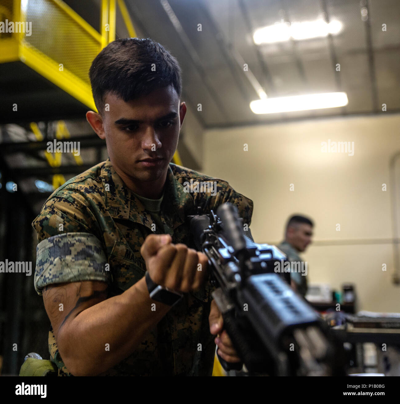Lance Cpl. Jordan Martinez conducts a functions check on a M240B medium machine gun at III Marine Expeditionary Force Headquarters Group armory, on Camp Hansen, Okinawa, Japan, October 12, 2016. Martinez repairs, inspects and maintains all weapons to ensure combat readiness. A big part of the Marine Corps is weapons maintenance and accountability. Martinez, from Pepperell, Massachusetts, is a small arms repair technician for III MHG, III Marine Expeditionary Force.  (U.S. Marine Corps photo by Cpl. Jessica Etheridge / Released) Stock Photo