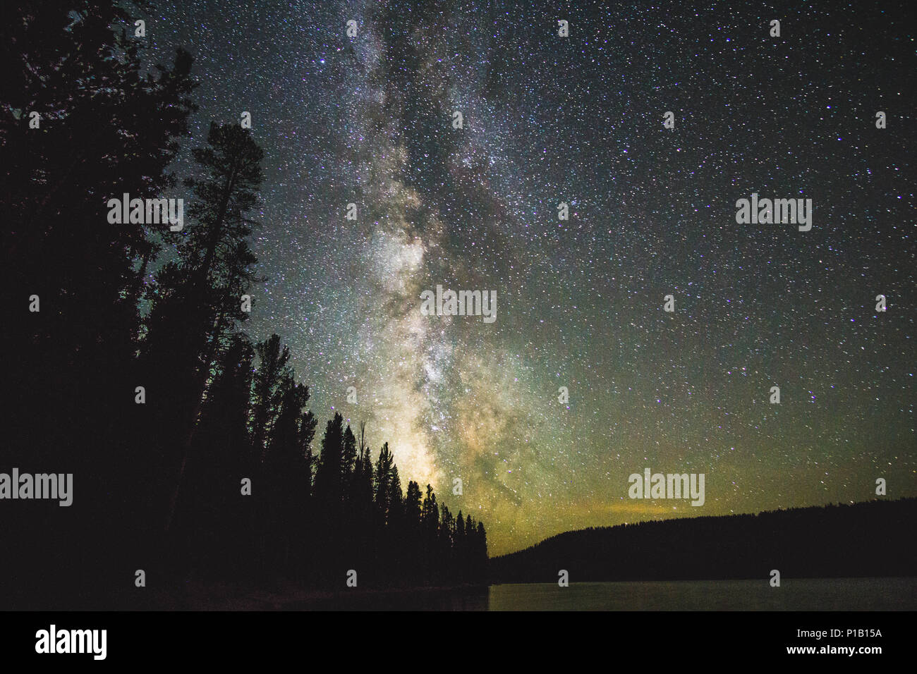 The Milky Way over Lewis Lake in Yellowstone National Park Stock Photo