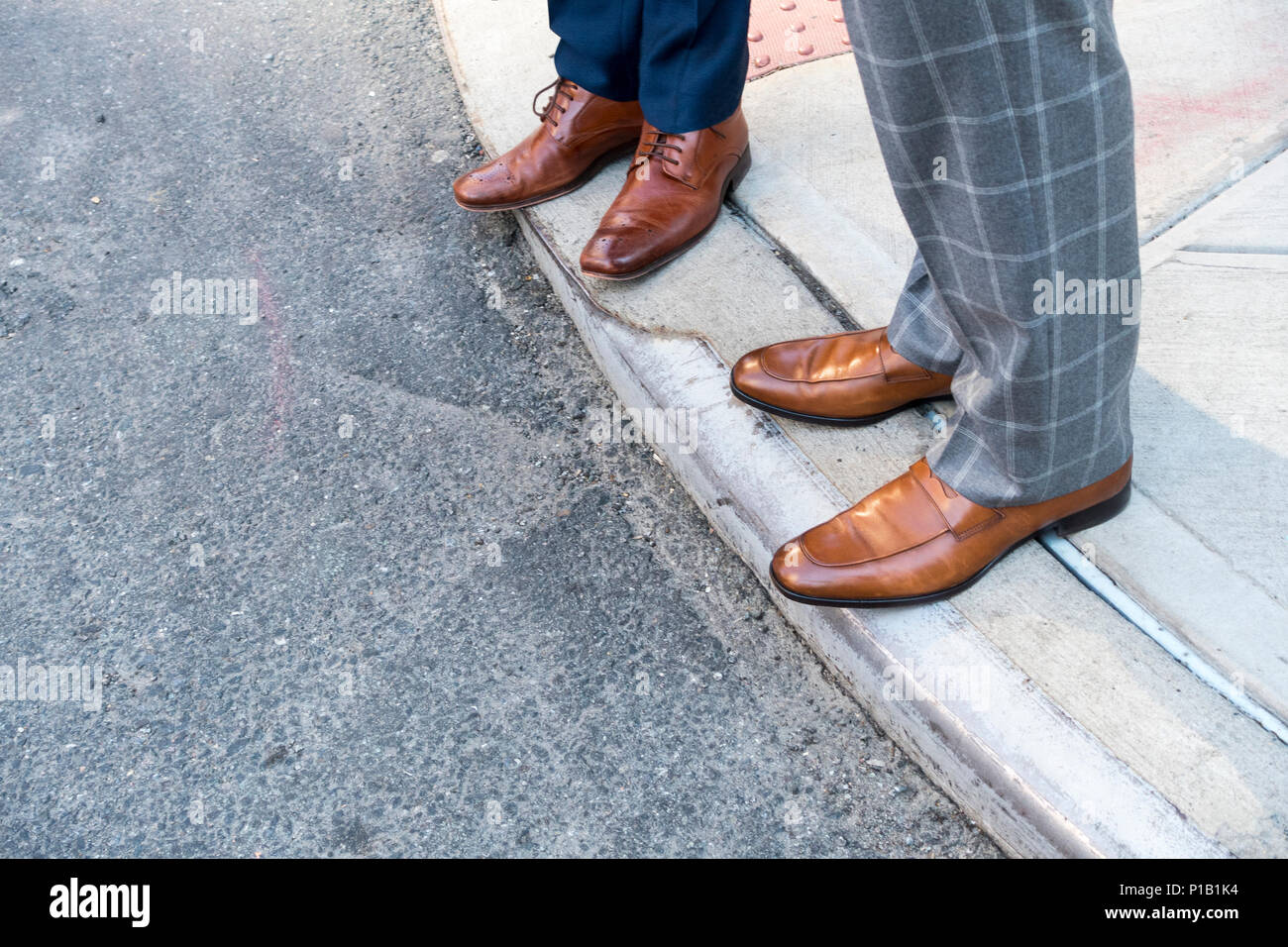 Two men in light brown dress shoes at the edge of a sidewalk corner Stock  Photo - Alamy
