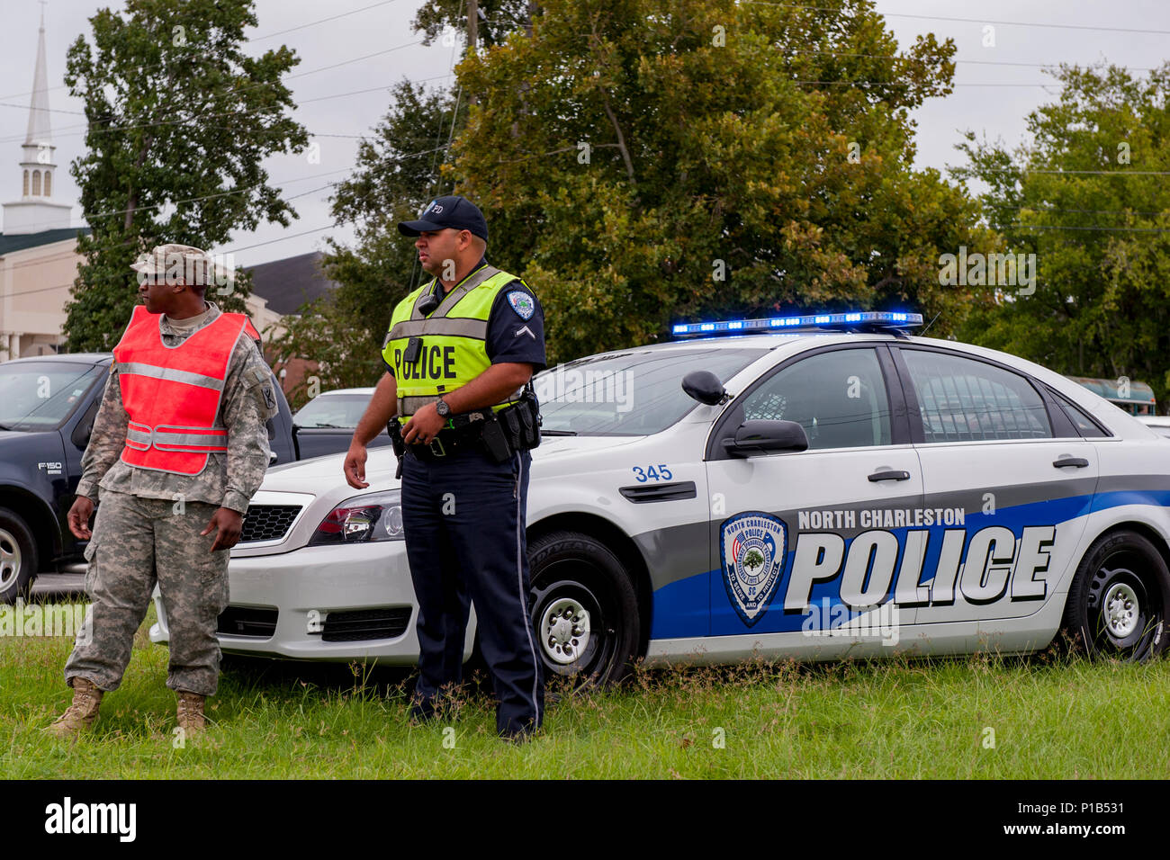 U.S. Army Pvt. 1st Class Bradley Burgess of C. Co. 1-118th Infantry Co., South Carolina Army National Guard and City of North Charleston Patrolman 1st Class Giovanni Brown manage a traffic control point in North Charleston, S.C., Oct. 5, 2016.  Hurricane Matthew peaked as a Category 4 hurricane in the Caribbean and was projected to pass over the southeastern U.S., including the S.C. coast. Approximately 1,400 S.C. National Guard Soldiers and Airmen were activated Oct. 4, 2016, to support coastal evacuations after Governor Nikki Haley declared a State of Emergency. (U.S. Army National Guard pho Stock Photo