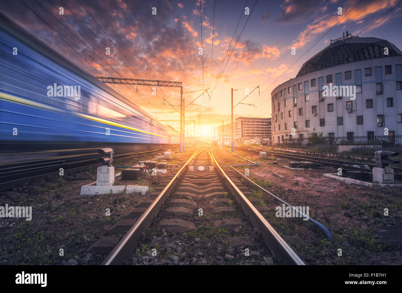 High speed passenger train in motion on railroad track at sunset