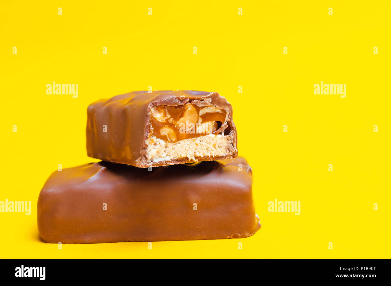 chocolate bars on a yellow background. sweets, candy Stock Photo - Alamy