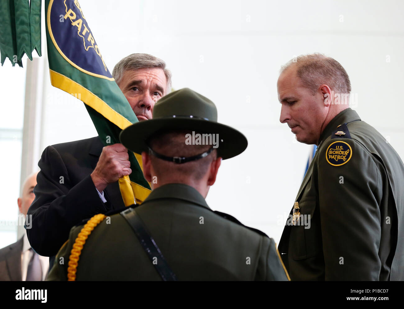 U.S. Customs and Border Protection Commissioner R. Gil Kerlikowske receives the U.S. Border Patrol flag from a member of the honor guard as he presents it to newly appointed Chief of U.S. Border Patrol Mark Morgan at the Ronald Reagan Building in Washington, D.C., October 11, 2016. CBP Photo by Glenn Fawcett Stock Photo