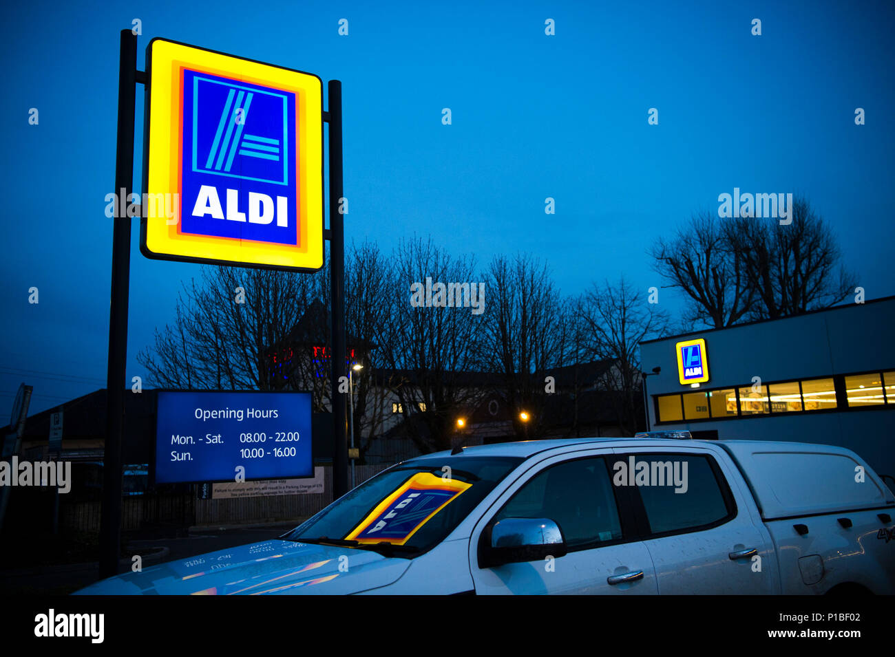 Aldi discount supermarket illuminated logo sign, exterior, night