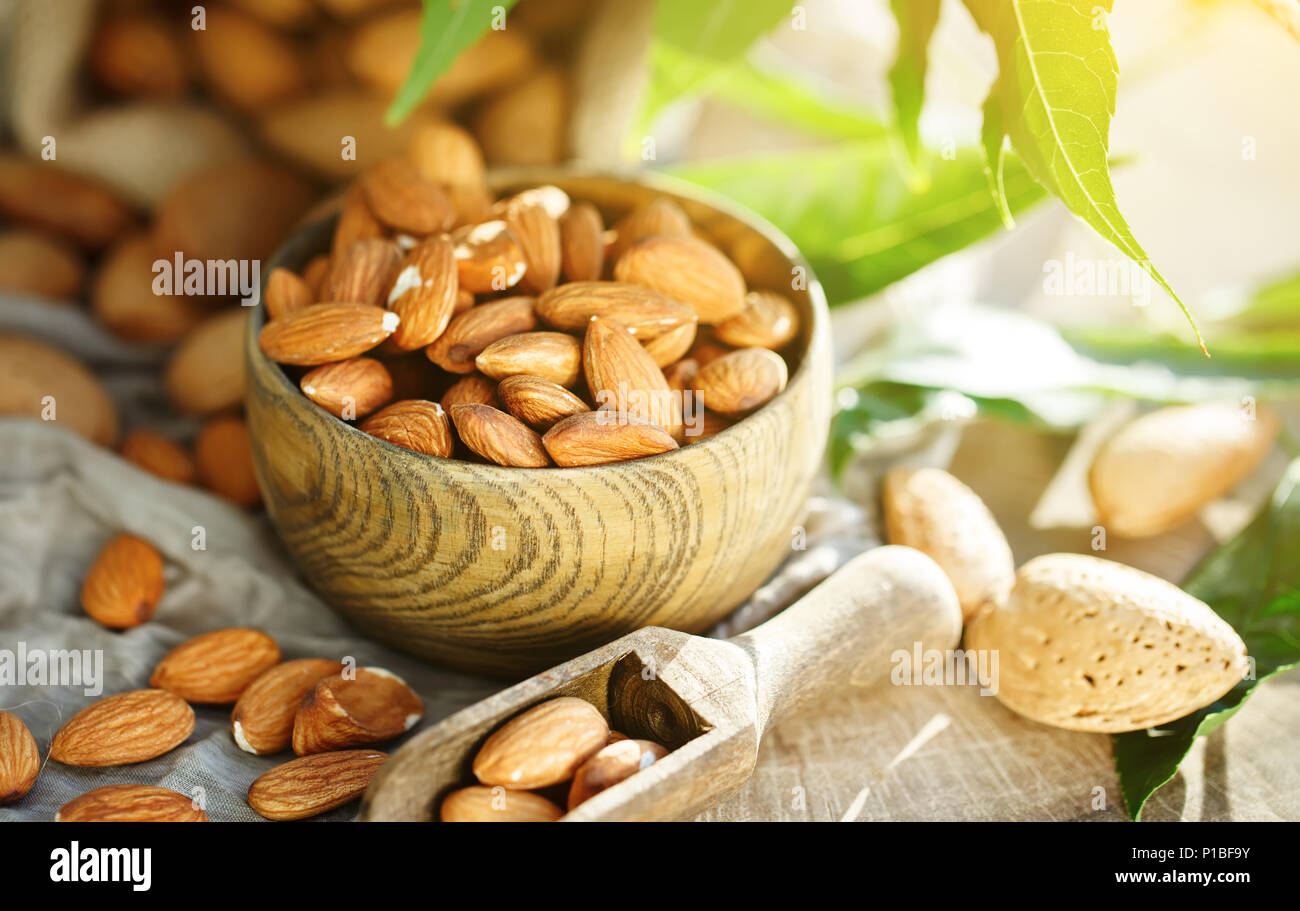Almond on a wooden table in the summer garden. Useful food. Stock Photo