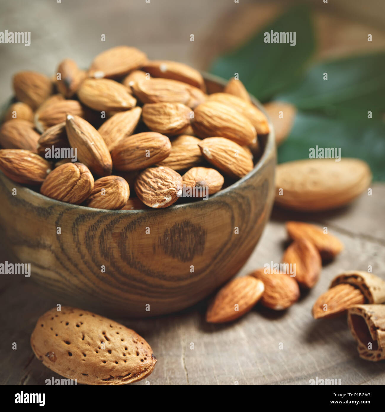 Almond on a wooden table in the summer garden. Useful food. Stock Photo
