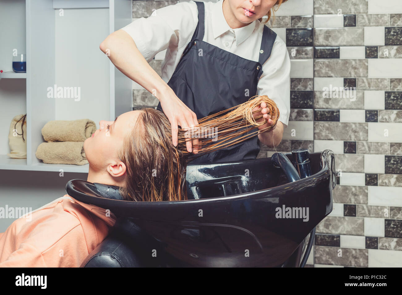 Hair Wash Procedure In A Beauty Salon A Hair Dresser Is Washing