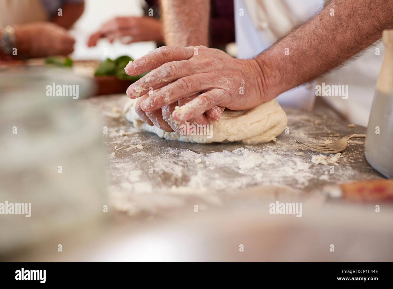 Close up man kneading pizza dough Stock Photo