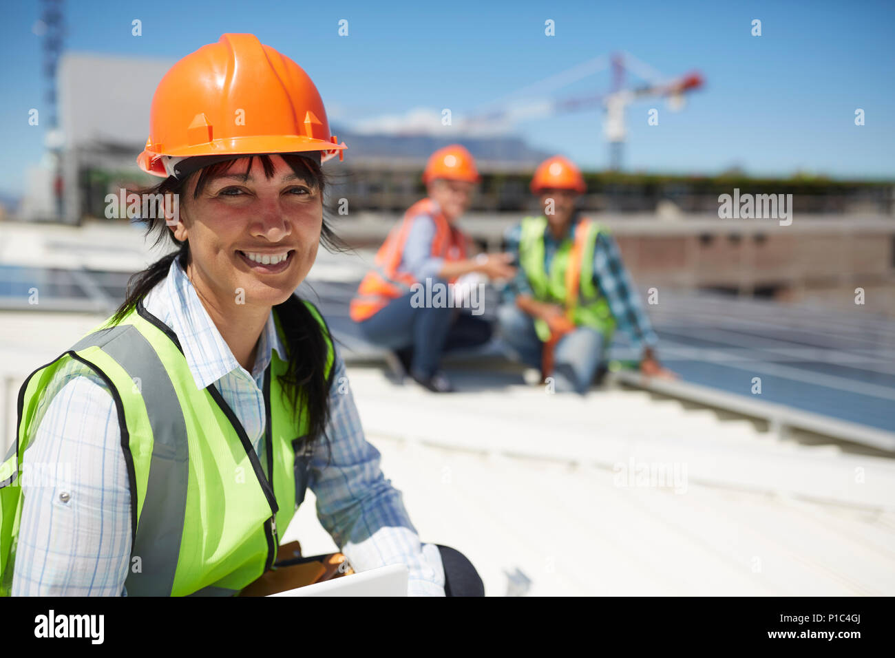 Portrait smiling, confident female engineer at sunny power plant Stock Photo