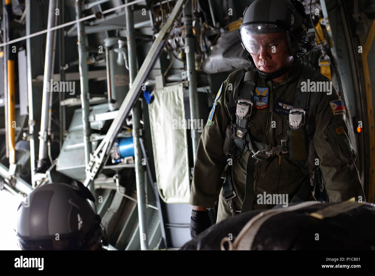 A Philippine Air Force C130 crew member observes airdrop preparations