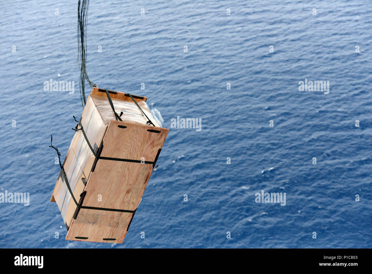 A U.S. Air Force C-130 conducts a low-cost, low-altitude airdrop bundle ...