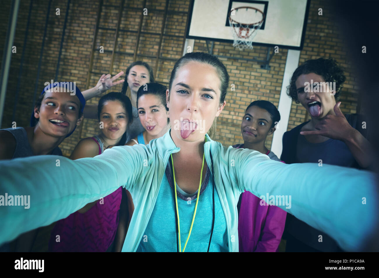 Female coach and high school kids taking a selfie Stock Photo