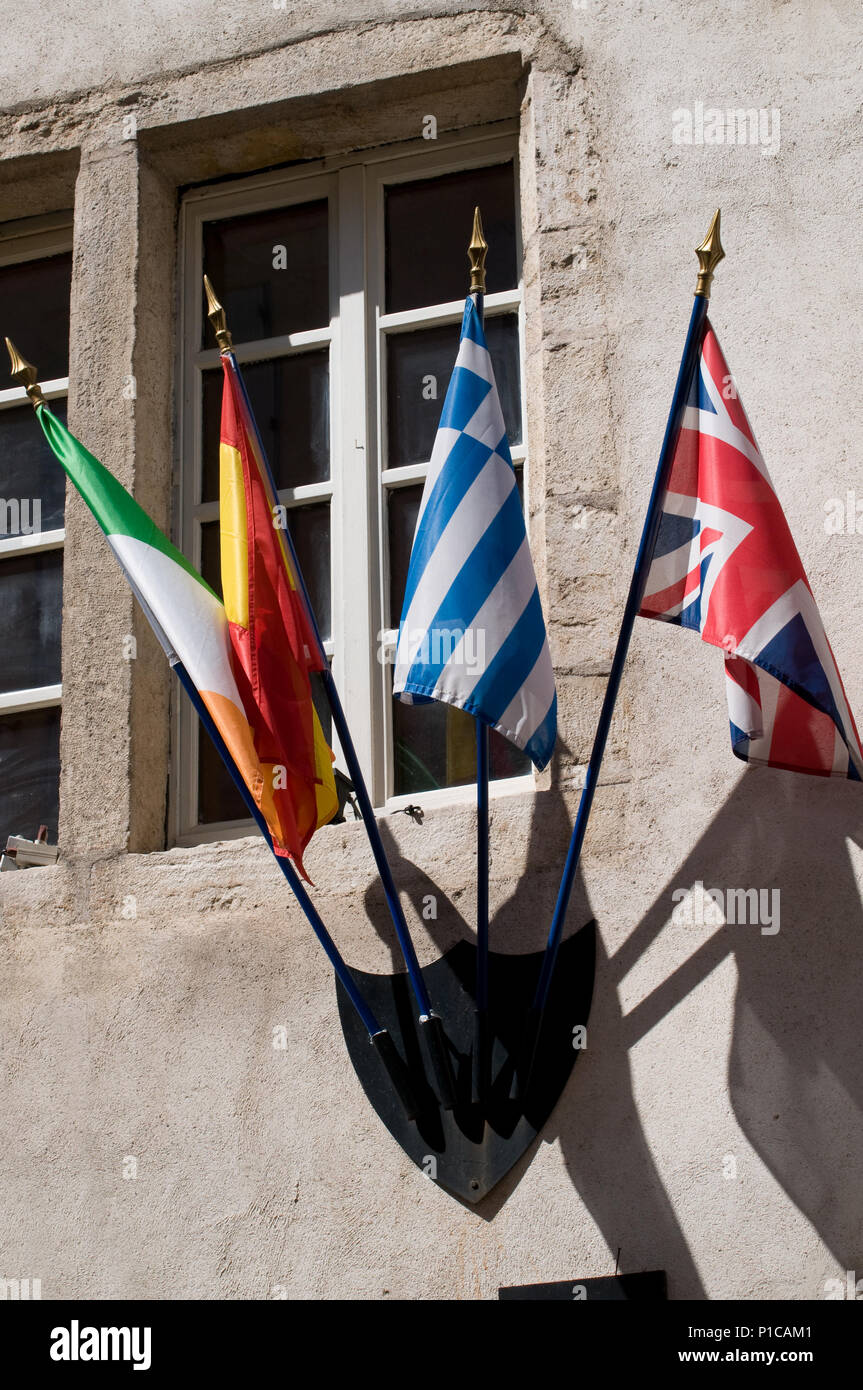 Flags including the Union Jack decorating the wall of a Pub on Rue Notre Dame Beaume France Stock Photo