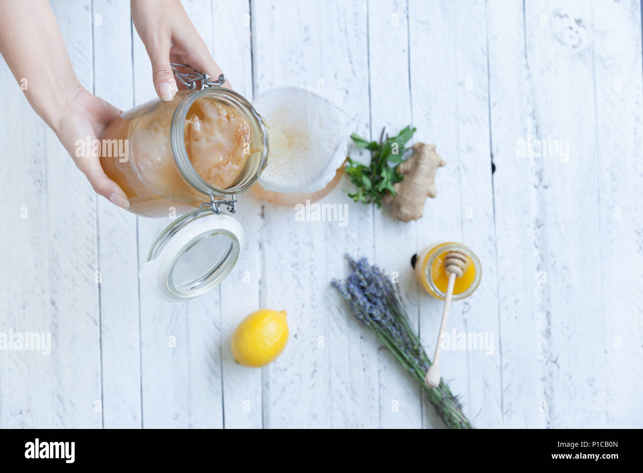 Young woman pouring the fermented green tea into a tea pot Stock Photo ...