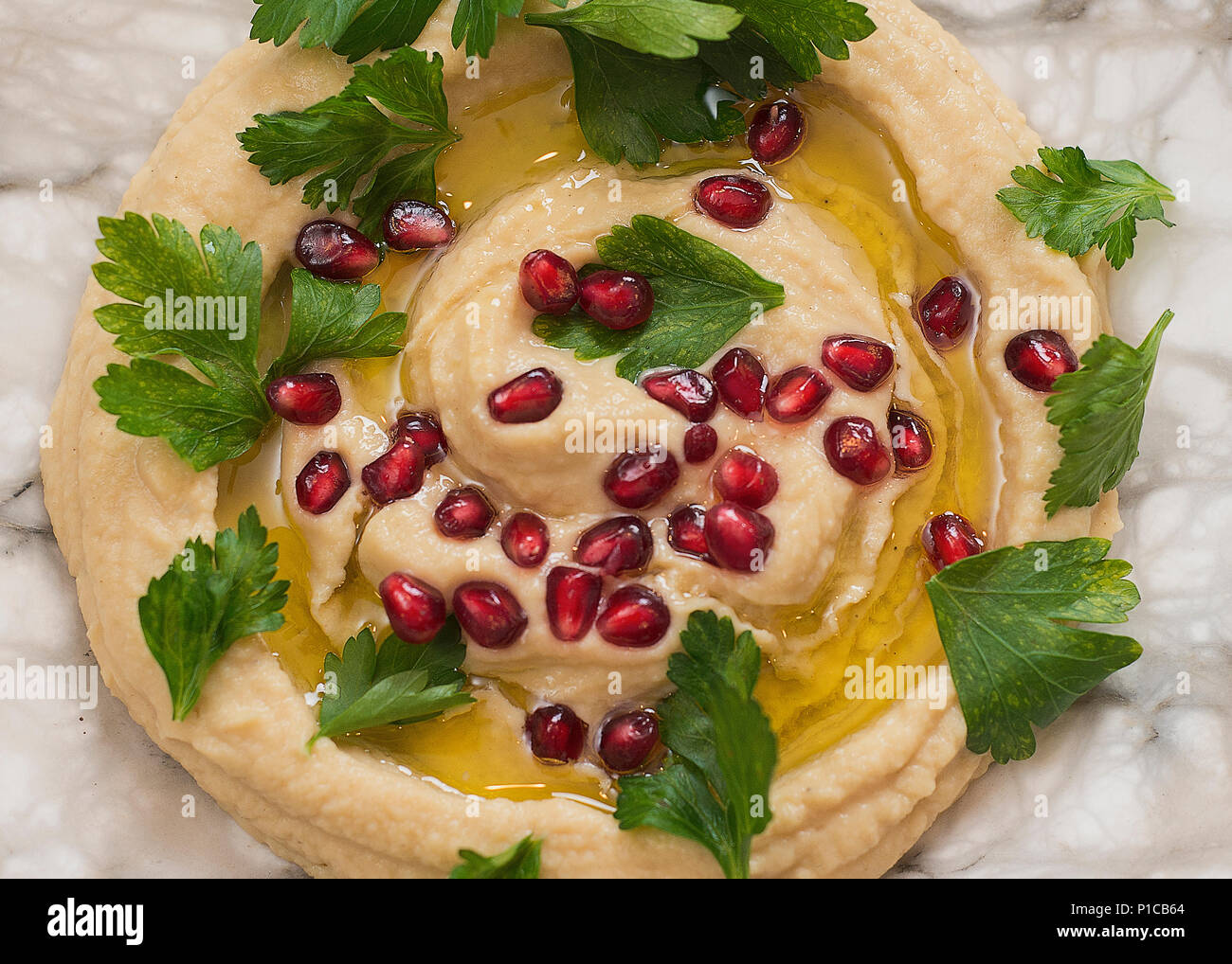 A plate of hummus dip prepared for a holiday celebration. Stock Photo