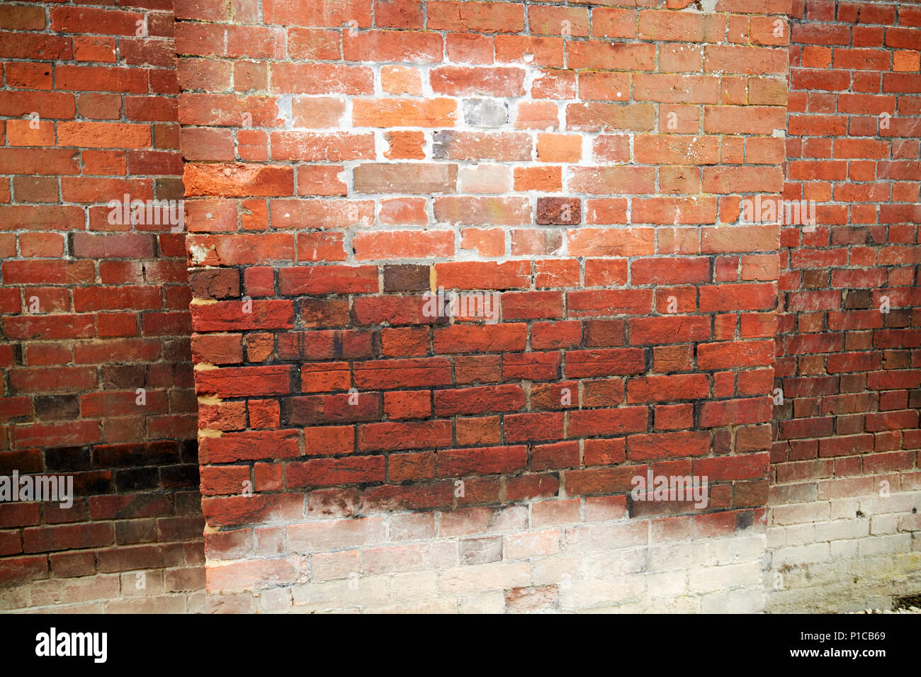 water damage lines including brick efflorescence in old historic building built over a stream avebury wiltshire england uk Stock Photo