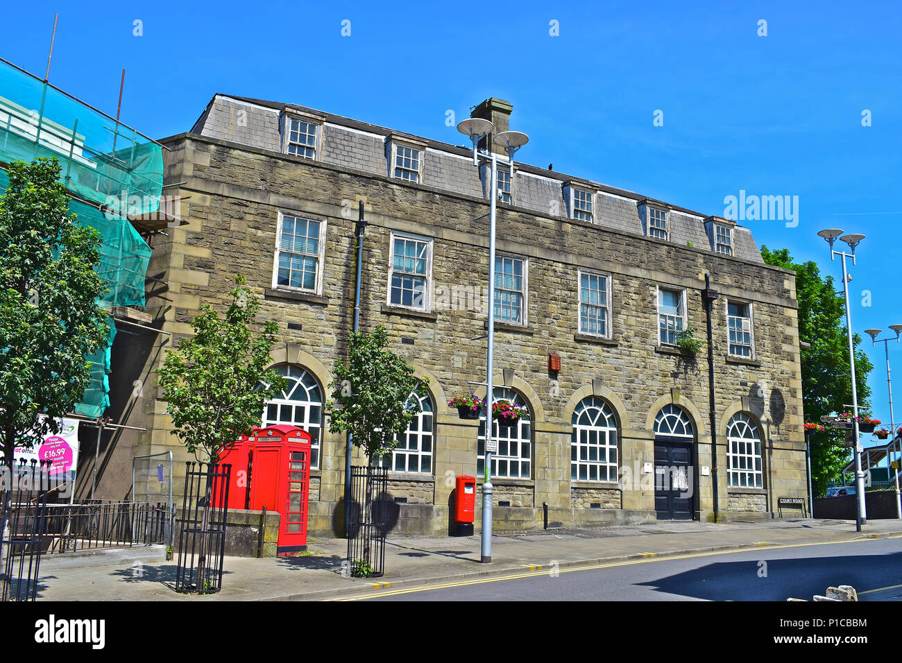 The Old Post Office on the corner of Station Hill and Court Road, Bridgend, South Wales. The 2 K6 telephone kiosks are Grade II Listed. Stock Photo