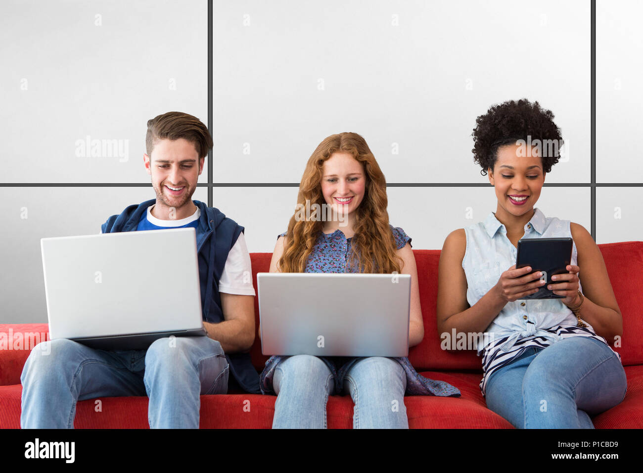 Composite image of creative team using laptops and digital tablet Stock Photo