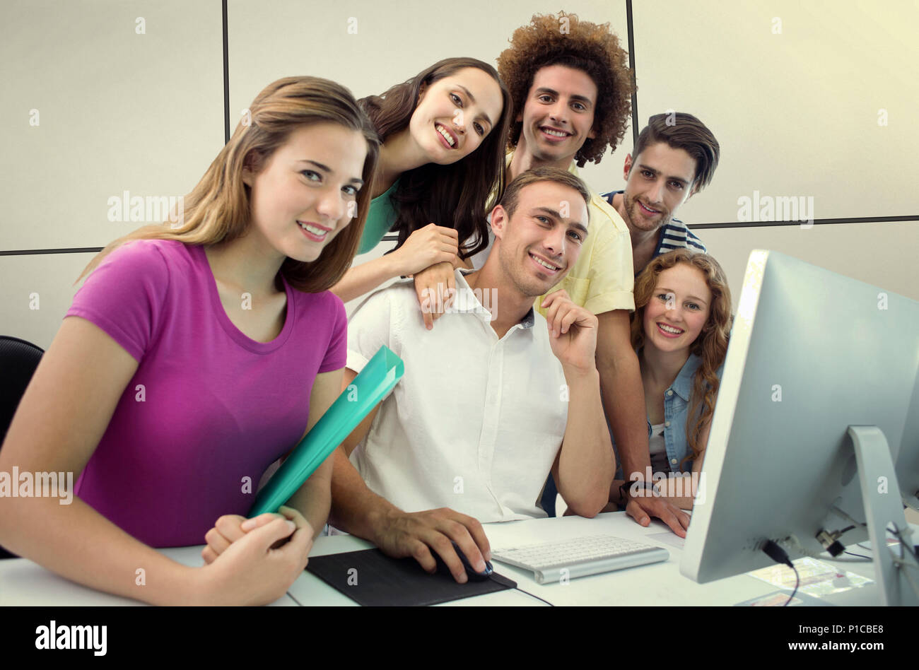 Composite image of smiling students in computer class Stock Photo