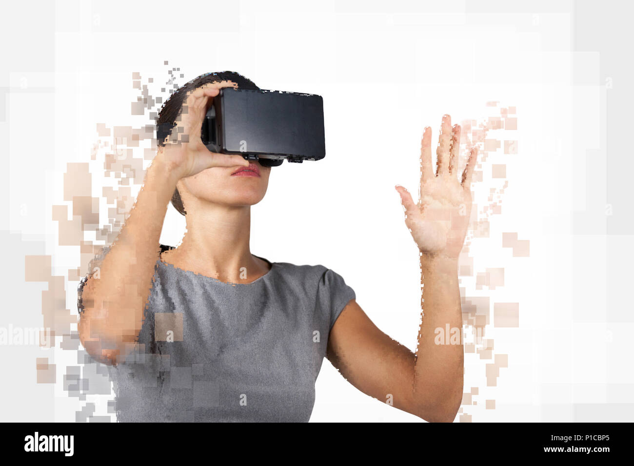 Digital composite of woman with a virtual reality simulator Stock Photo