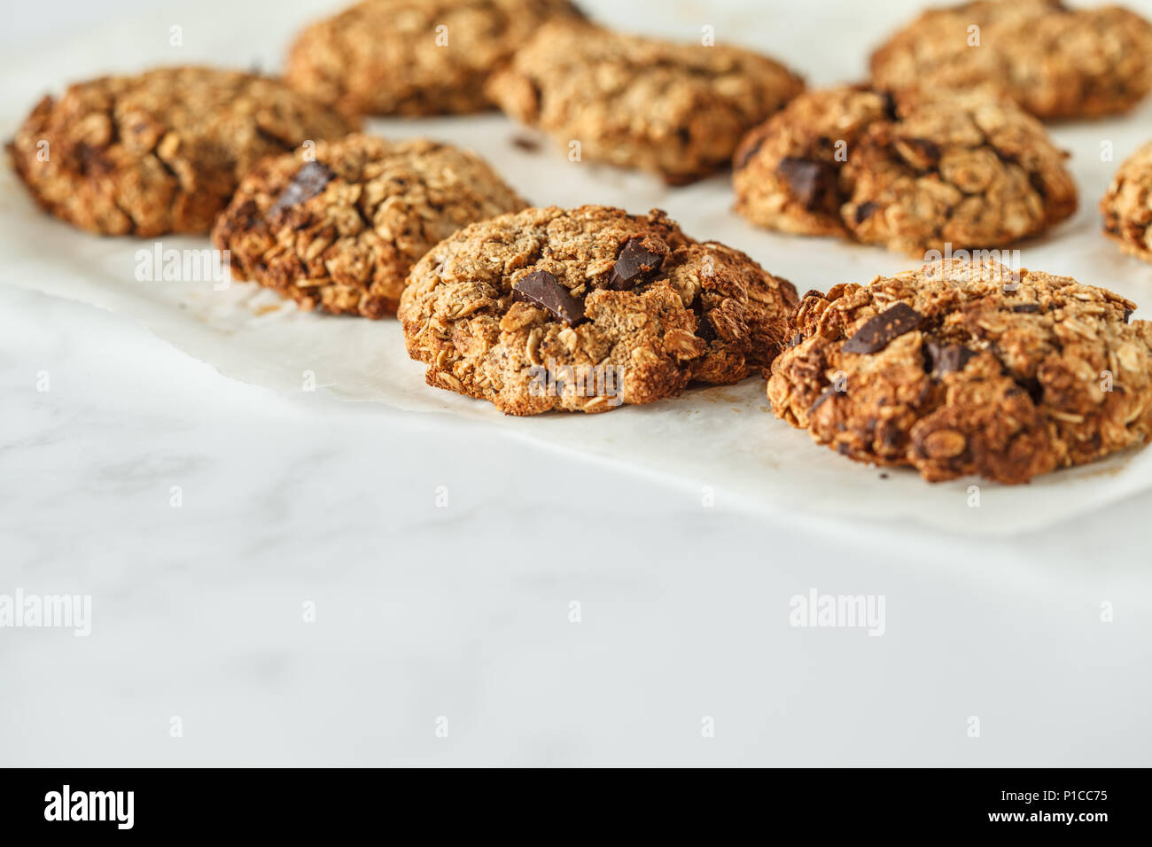 Vegan oatmeal cookies with chocolate on a light background. Food blog style concept. Stock Photo