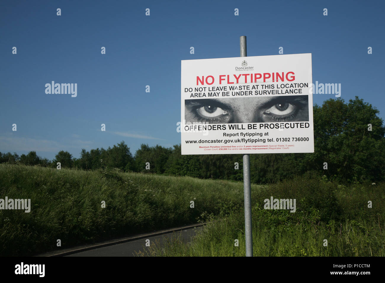 No fly tipping sign seen here near a very active illegal tipping place on Tickhill Road on the A631 on the outskirts of Bawtry, South Yorkshire, UK Stock Photo