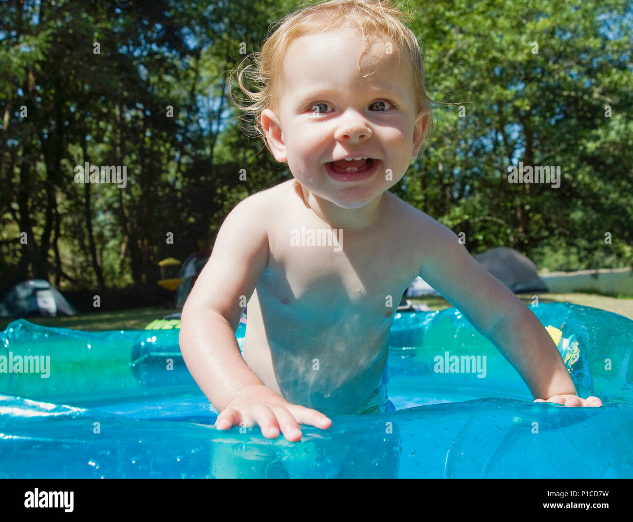 An 11 month old baby in a kiddie pool Stock Photo