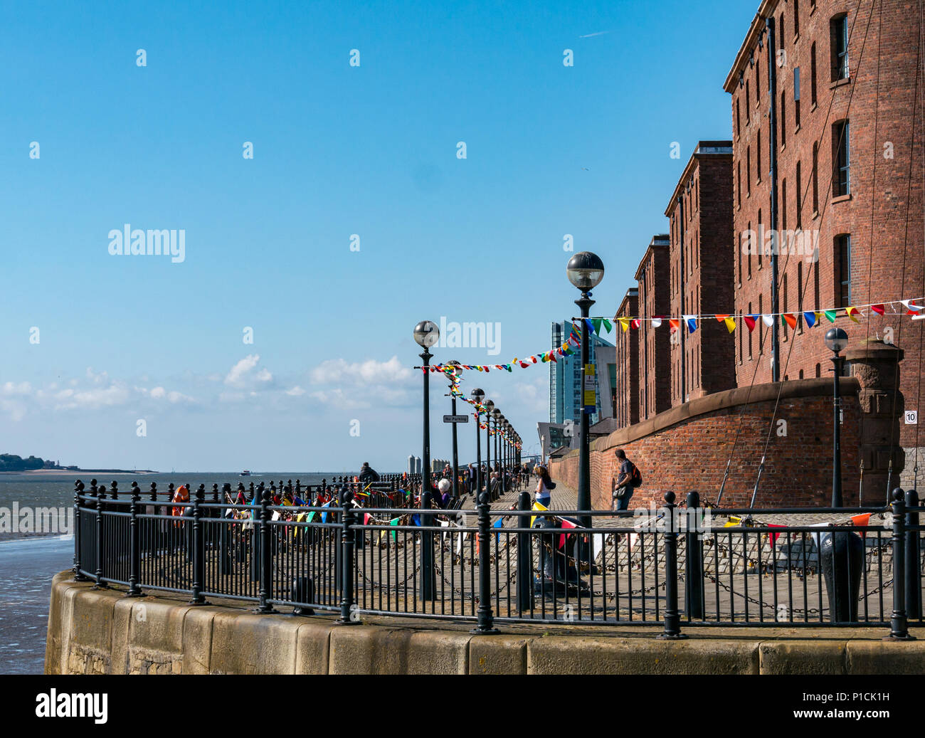 Albert Dock, Liverpool, England, United Kingdom, 11th June 2018. UK weather: sunshine on the Mersey. A beautiful sunny day with blue sky along the River Mersey in Liverpool for visitors and locals enjoying a stroll along the promenade with restored warehouse buildings at Albert Dock Stock Photo