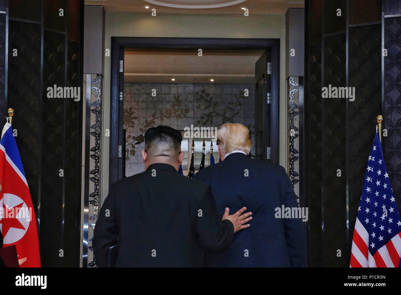 Singapore. 12th June, 2018. Top leader of the Democratic People's Republic of Korea (DPRK) Kim Jong Un (L) and U.S. President Donald Trump leave after signing a joint statement in Singapore on June 12, 2018. Credit: Ministry of Communication and Information of Singapore/Xinhua/Alamy Live News Stock Photo