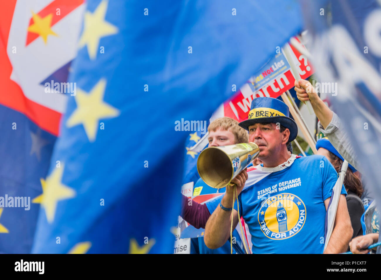London, UK. 12th june 2018. Stand of Defiance European Movement (SODEM) spokesperson and founder, Steven Bray, uses a megaphone to make himself heard, protesting behind the TV camera positions - As the commons debate on the Brexit deal approaches, members of SODEM and other anti-Brexit, pro-EU groups gather outside Parliament for a Pies not Lies protest. Credit: Guy Bell/Alamy Live News Stock Photo