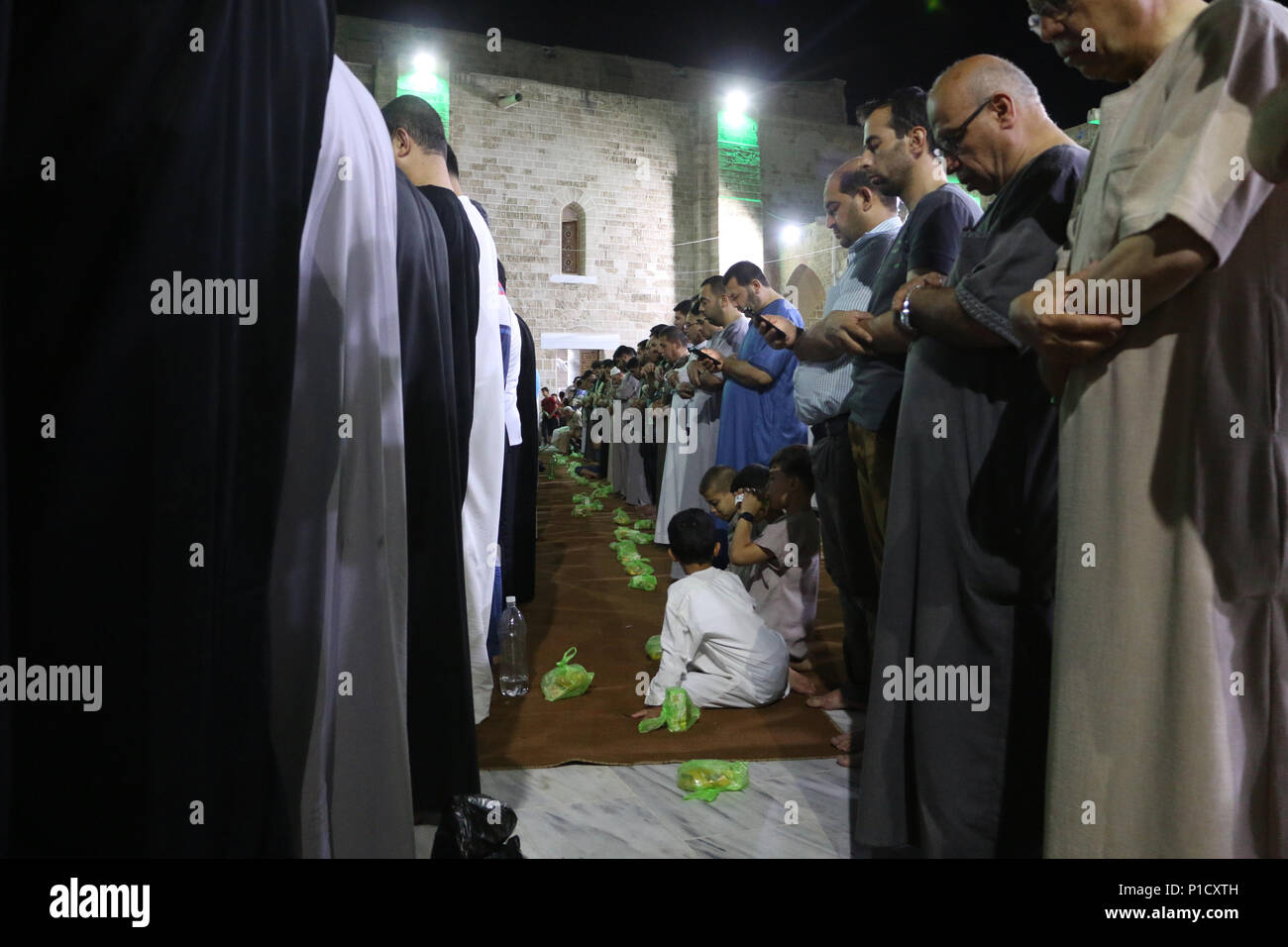 Muslims seen performing prayers during the ramadan. Palestinian worshippers attend a night prayer during Laylat Al-Qadr, on the 27th day of the holy fasting month of Ramadan at al-Omari mosque in Gaza City. Laylat Al-Qadr is the holiest night in the Ramadan month which commemorates the revealing of the holy book of Quran to Prophet. Stock Photo