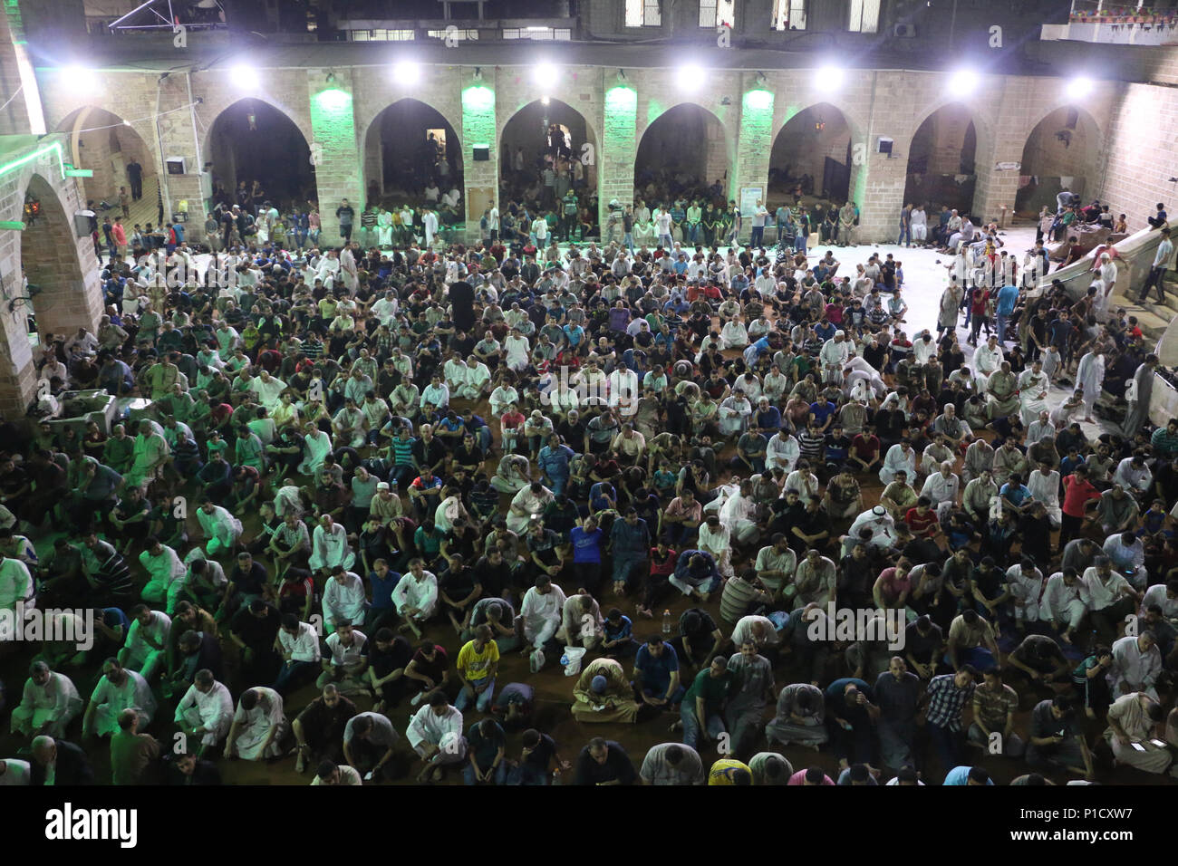 General view from inside the mosque as muslims performs night prayer. Palestinian worshippers attend a night prayer during Laylat Al-Qadr, on the 27th day of the holy fasting month of Ramadan at al-Omari mosque in Gaza City. Laylat Al-Qadr is the holiest night in the Ramadan month which commemorates the revealing of the holy book of Quran to Prophet. Stock Photo