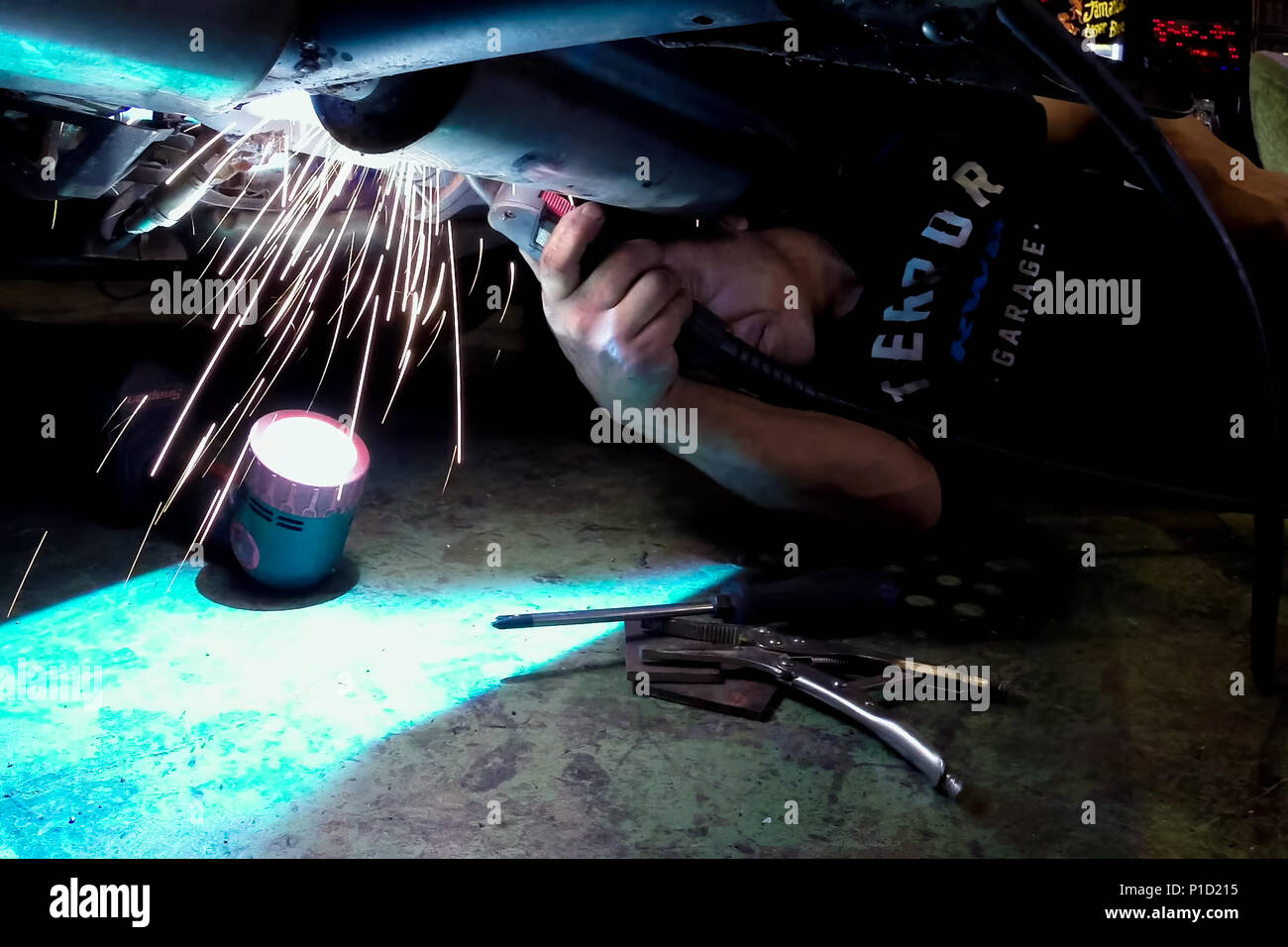 Welding works during the car repair. Exhaust system repair Stock Photo