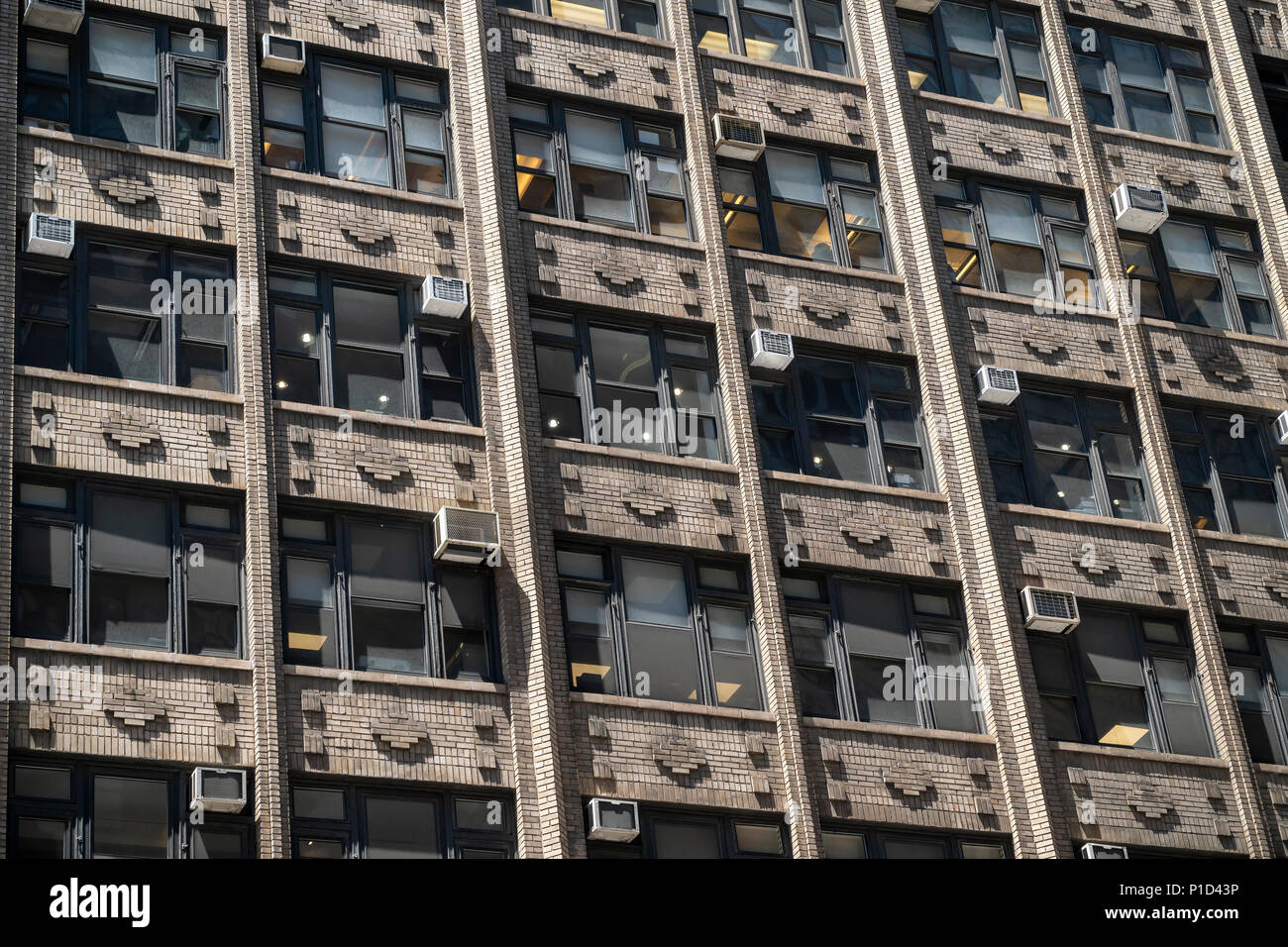 Air conditioners sprout from windows in an older office building in New York on Thursday, May 24, 2018. (Â© Richard B. Levine) Stock Photo