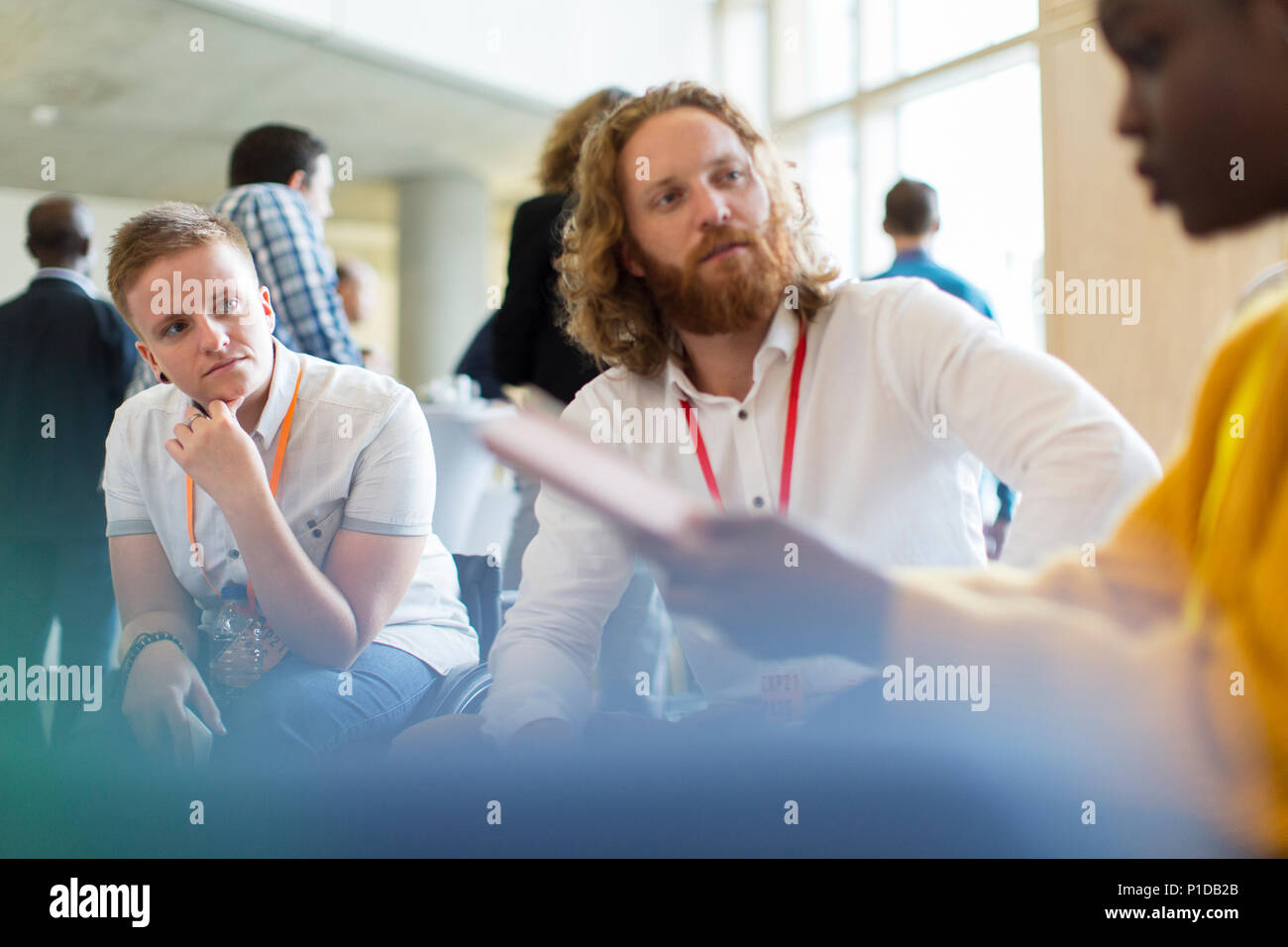 Attentive business people talking at conference Stock Photo