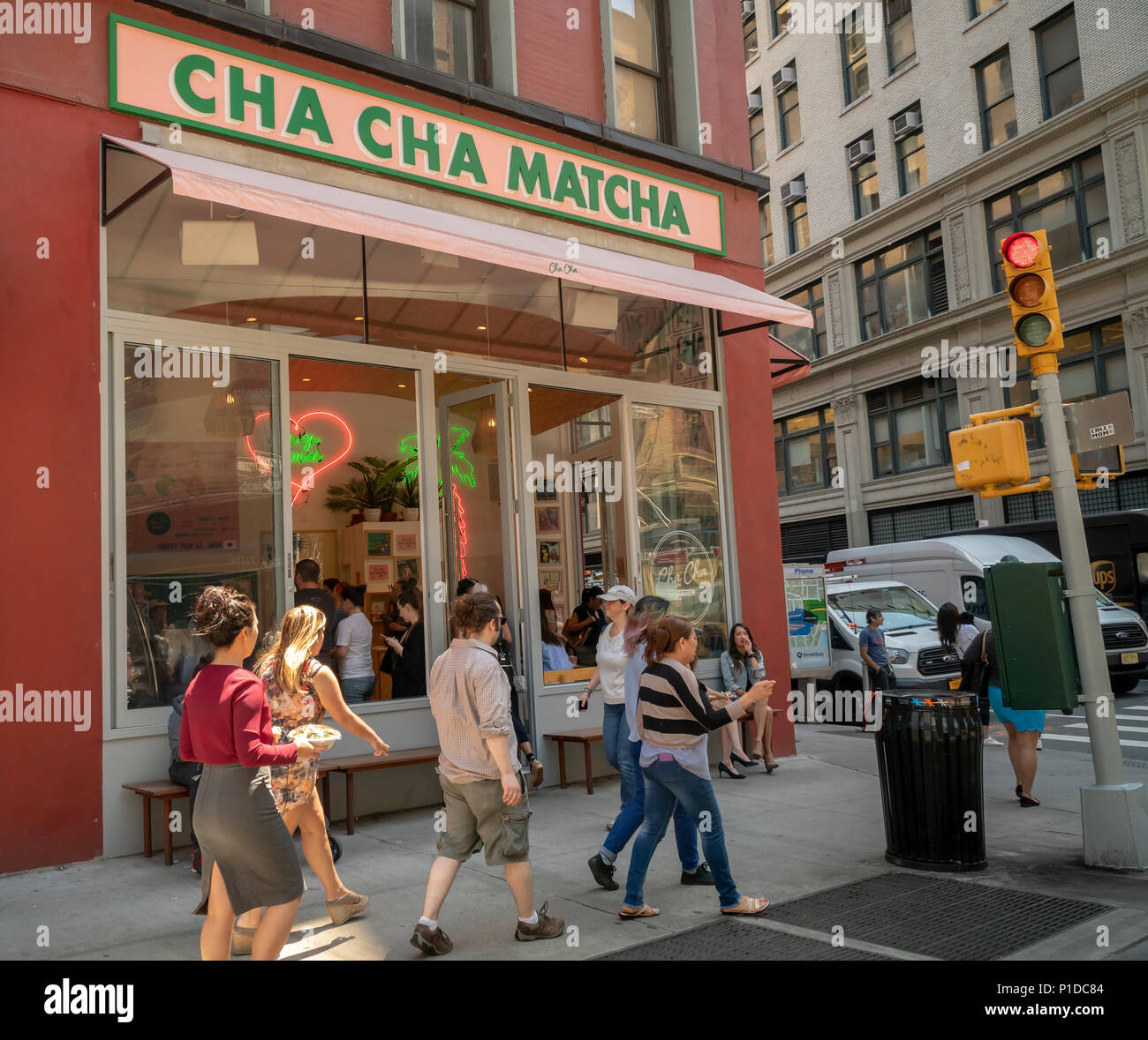 People line up for their fix of matcha at Cha Cha Matcha in the NoMad neighborhood of New York on Thursday, May 24, 2018. The popular beverage, matcha, is ground green tea and is used in Cha Cha Matcha to make instagrammable beverages popular with millennials. Loaded with antioxidants matcha supposedly has medicinal qualities. (© Richard B. Levine) Stock Photo