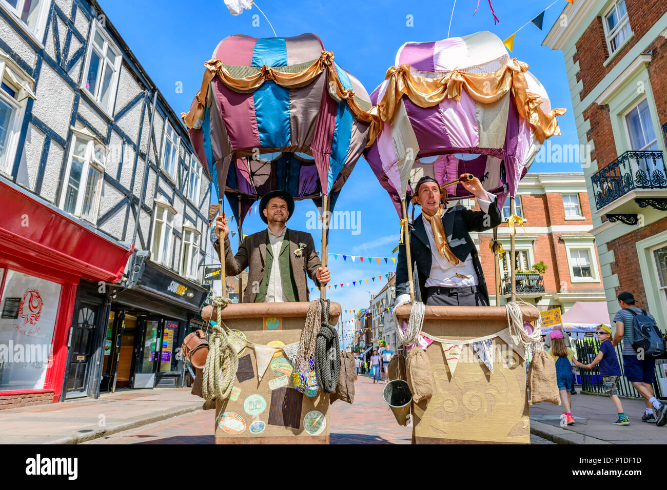 Two street entertainers in mock hot air balloons Stock Photo