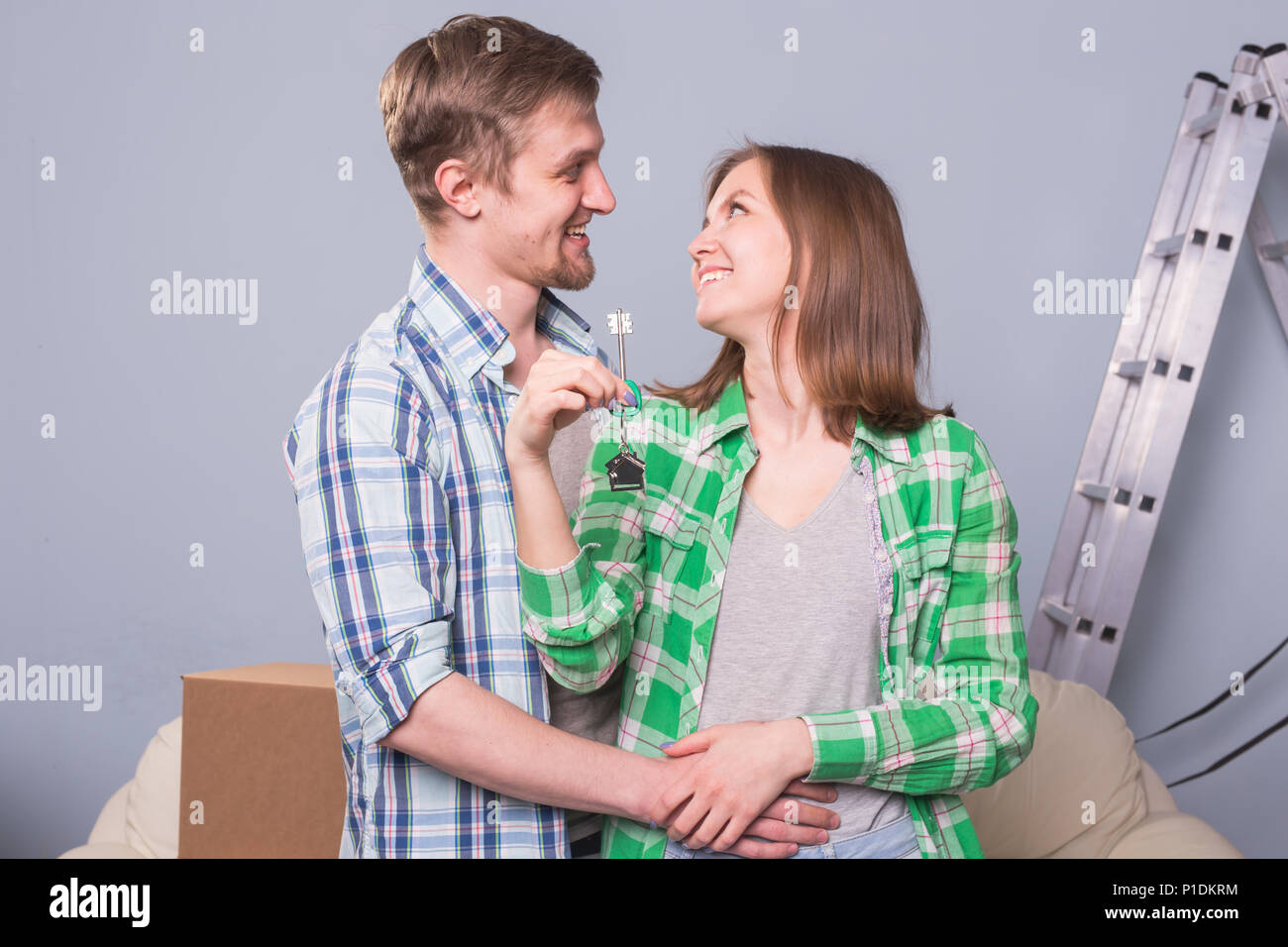 Happy love couple in her new home holding key Stock Photo - Alamy