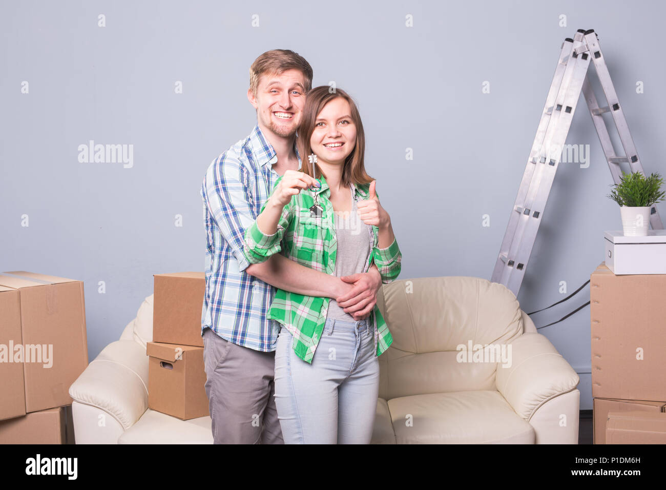 Happy love couple in her new home holding key Stock Photo - Alamy