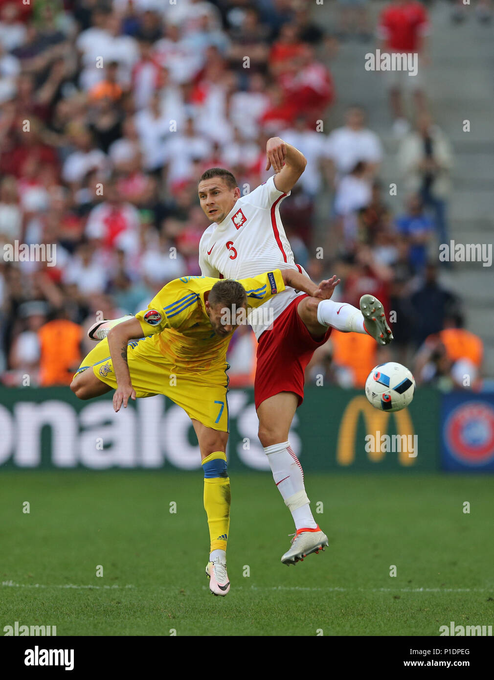 MARSEILLE, FRANCE - JUNE 21, 2016: Andriy Yarmolenko of Ukraine (L) and Artur Jedrzejczyk of Poland in action during their UEFA EURO 2016 game at Stad Stock Photo