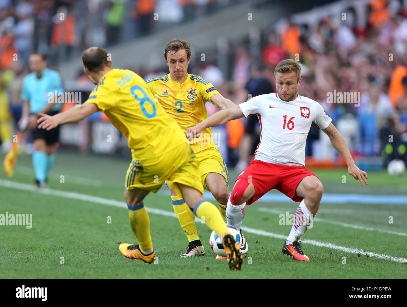 MARSEILLE, FRANCE - JUNE 21, 2016: Roman Zozulya and Bohdan Butko of Ukraine fight for a ball with Jakub Blaszczykowski of Poland during their UEFA EU Stock Photo