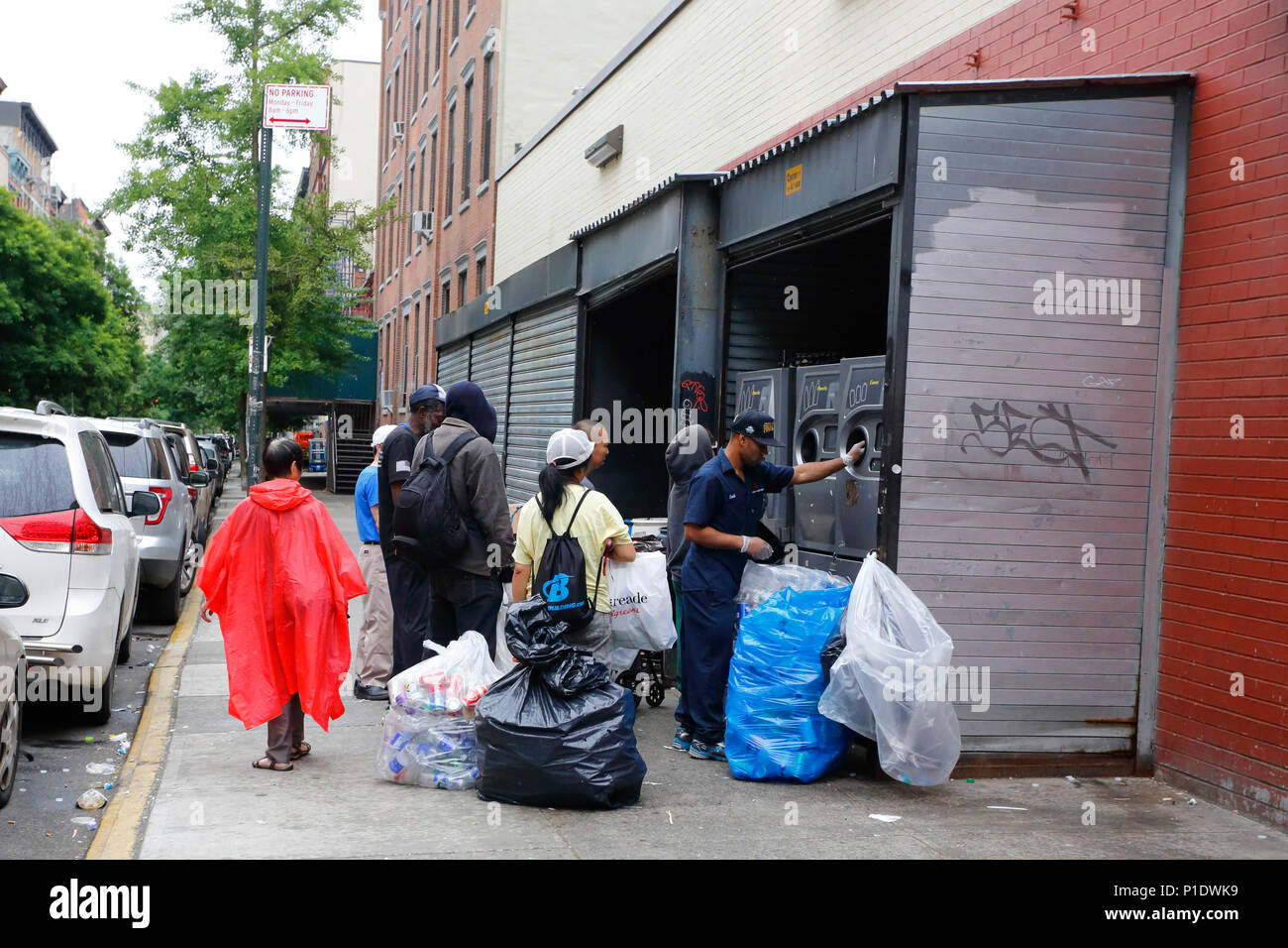 People queued at a bottle deposit redemption machine at a supermarket
